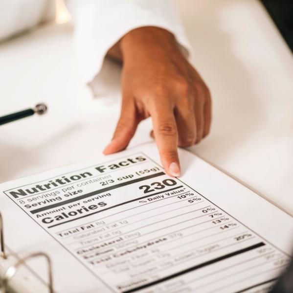 person points at printed nutrition label 