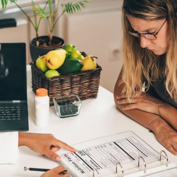 person points to info on nutrition label